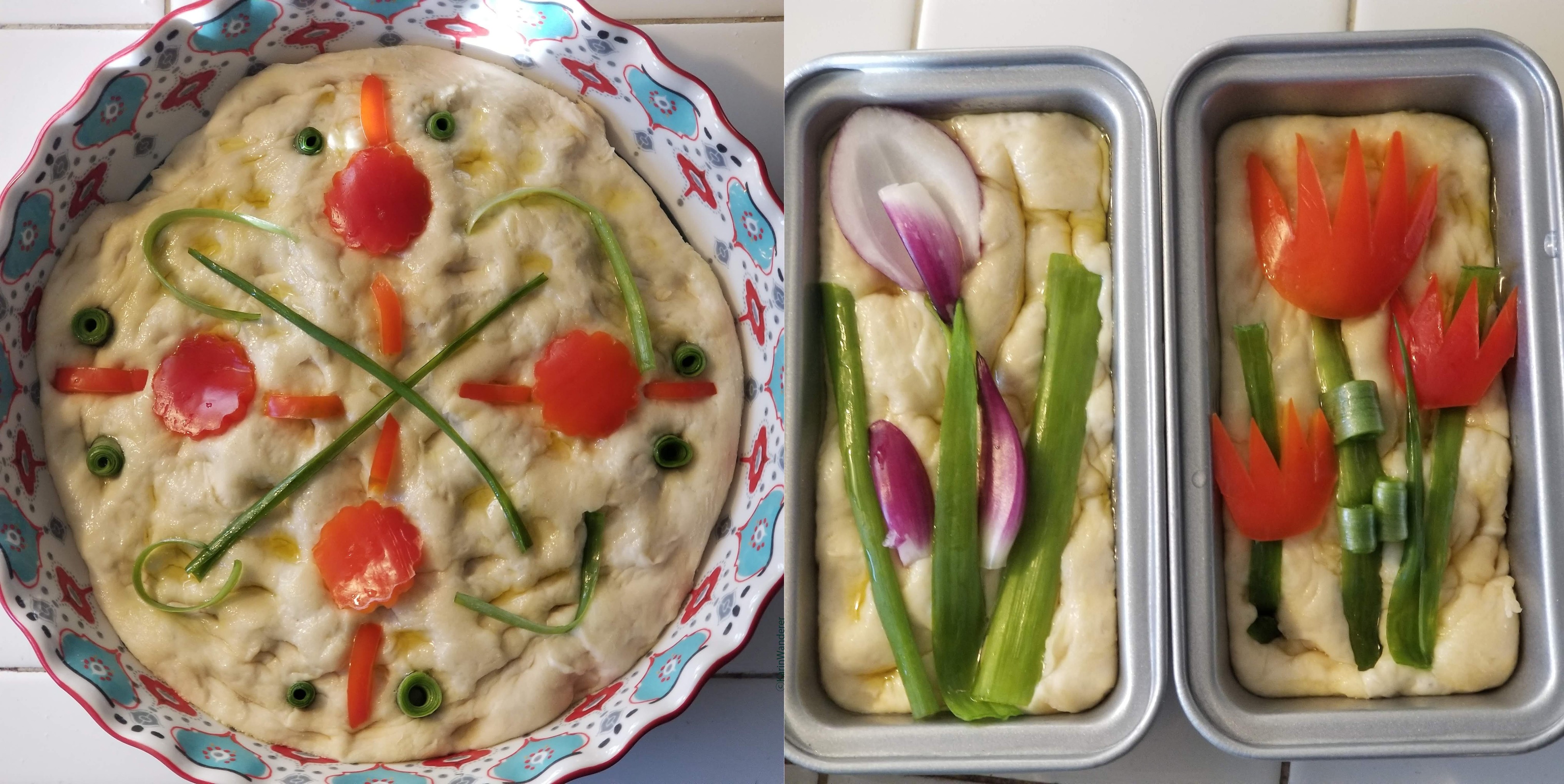 Photo of 3 loaves of focaccia decorated with raw vegetables, about to go into the oven. Loaf 1: circular loaf with a simple mandala made from green onions & red peppers. Loaf 2: small rectangular loaf using red & green onions to look like irises. Loaf 3 : small rectangular loaf using red peppers & green onions to look like tulips.