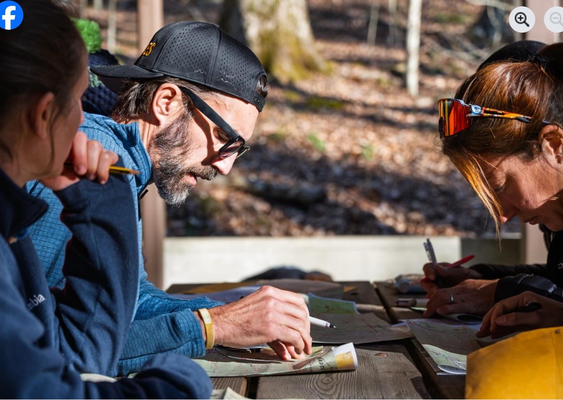 2 runners at the Barkley look over their maps